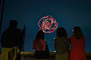 Illuminated drones fly over a string quartet