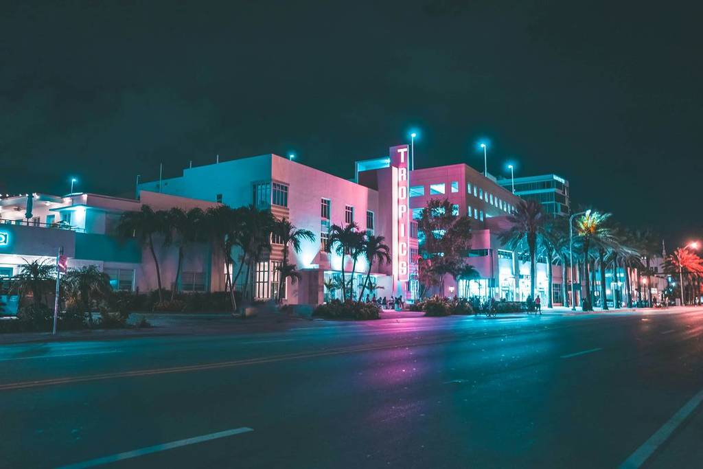 The main street in Miami lit by neon lights.