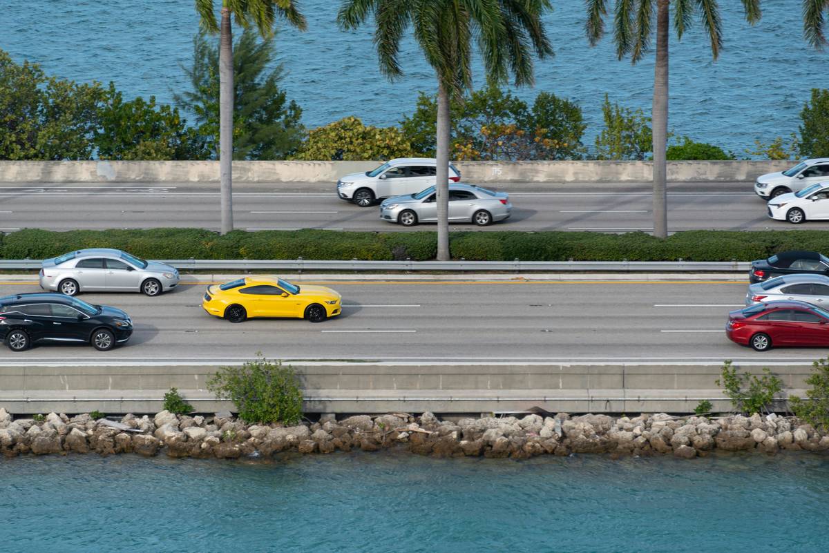 Cars on the road in Miami between body of water