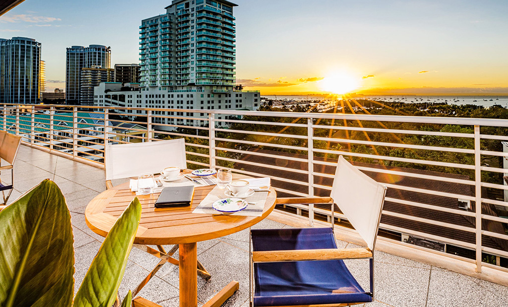 A chair ans tabe overlooking the Miami sunset at Mrc. C. Coconut Grove.