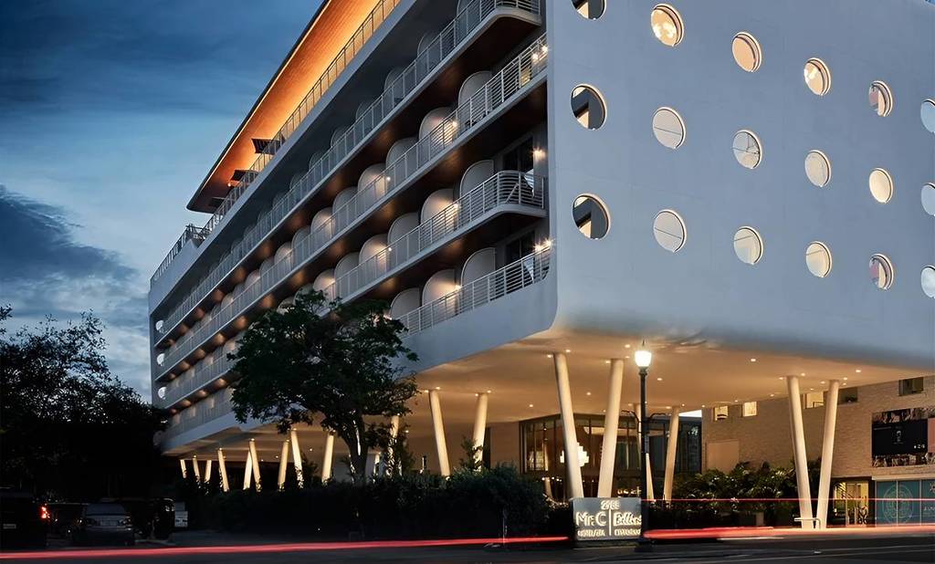 The white, modern edifice of Mrc. C. Coconut Grove at night.