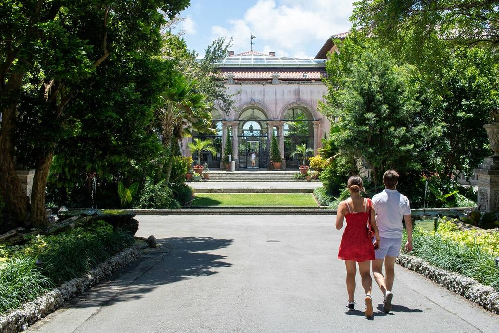 A man and a woman walking to Vizcaya Museum and Gardens