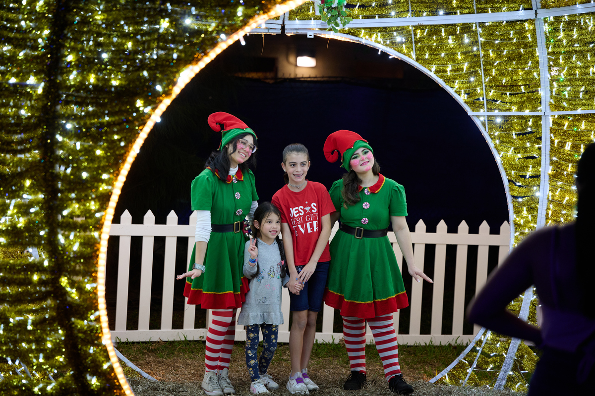 Kids and elves in costume posing at a Christmas photo op