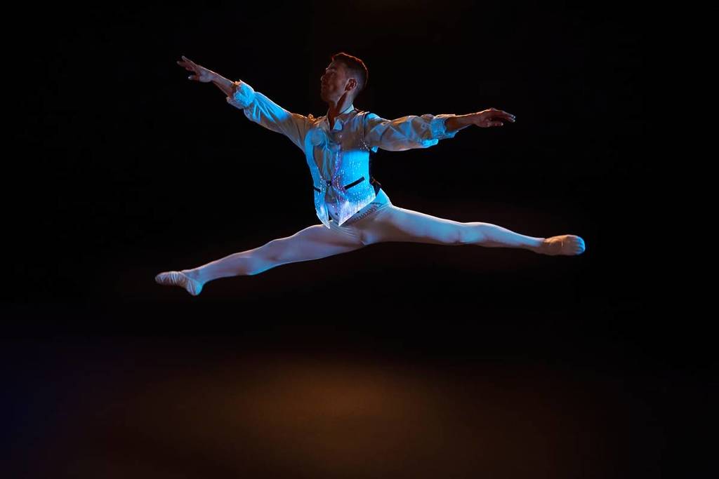 ballerina jumps on stage