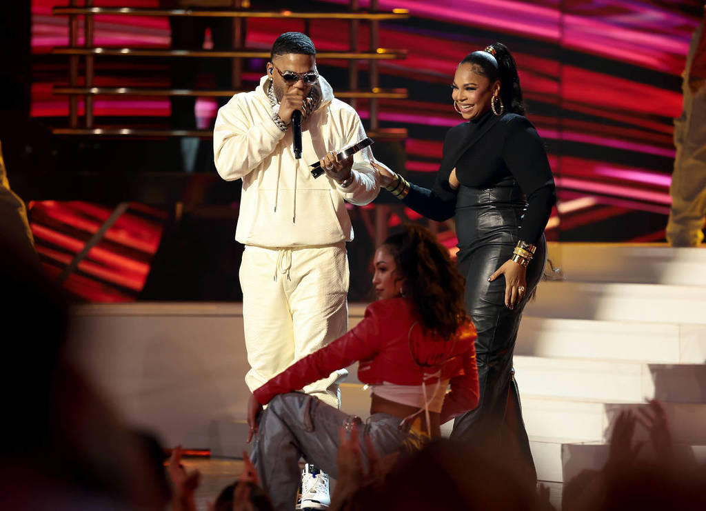 HOLLYWOOD, CALIFORNIA - MARCH 17: (L-R) Nelly accepts the Landmark Award from Ashanti onstage at the 2025 iHeartRadio Music Awards at Dolby Theatre on March 17, 2025 in Hollywood, California.