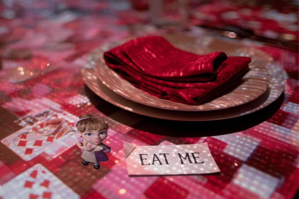 projection mapping on table depicts scene from alice in wonderland at sensory feast