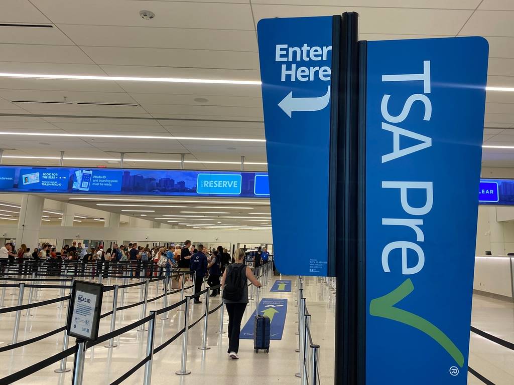 Orlando, Florida - June 2, 2025: A traveler walks through a TSA Pre Check security line at Terminal C at Orlando International Airport.