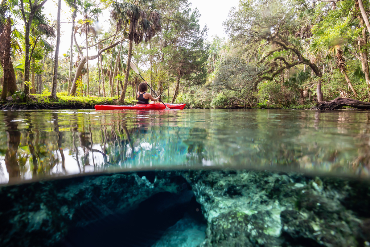 Kayaking in a lake near an underwater cave formation