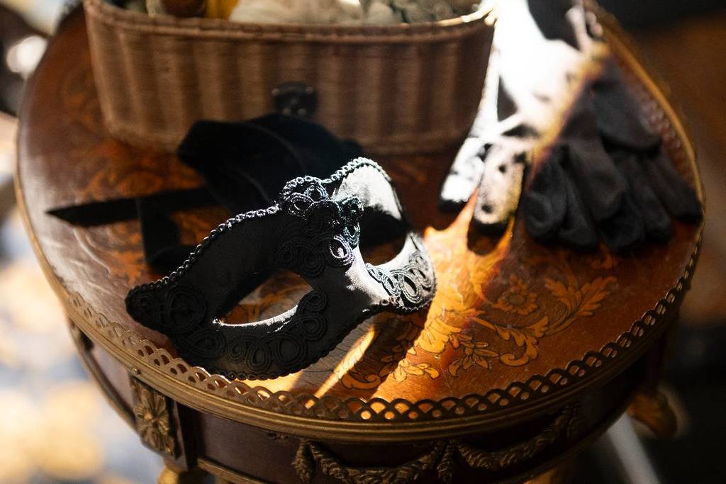 A masquerade mask on a regal table from Bridgerton