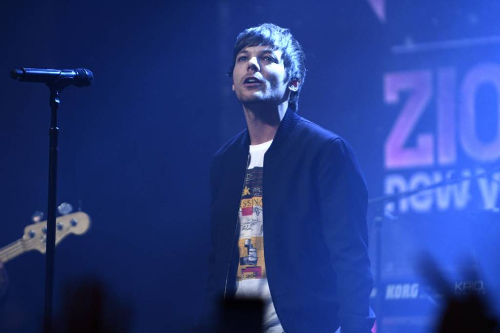 Louis Tomlinson on stage performing live
