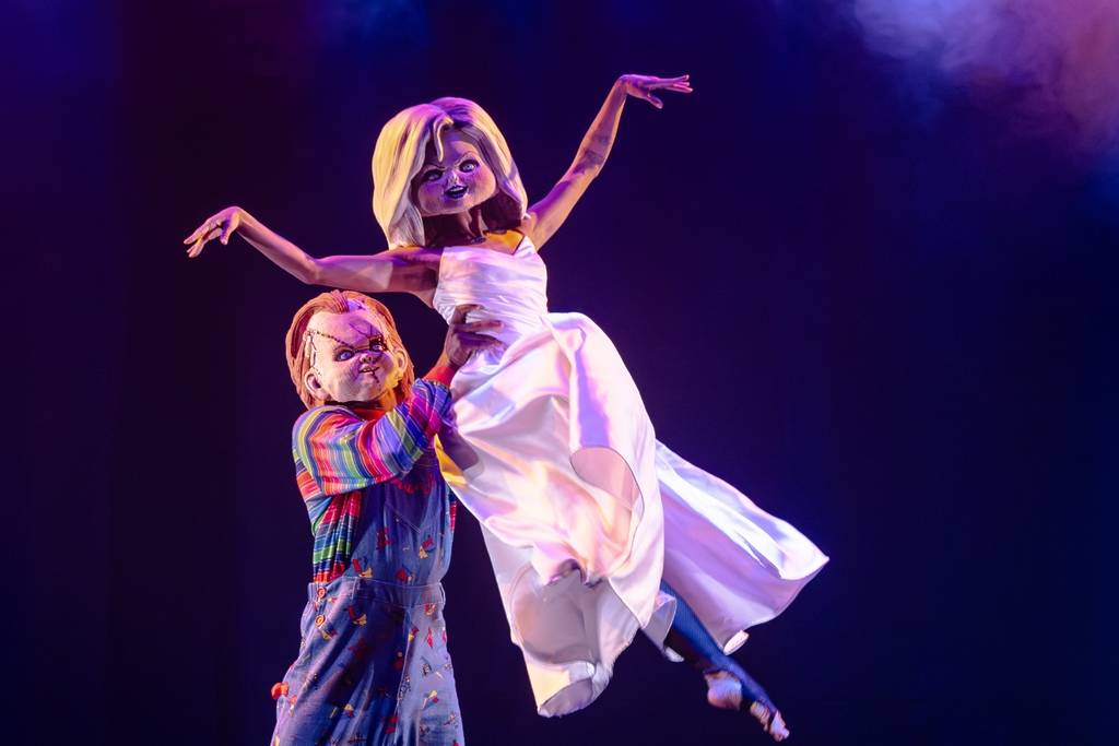 Burlesque performers wear horror-themed outfits onstage