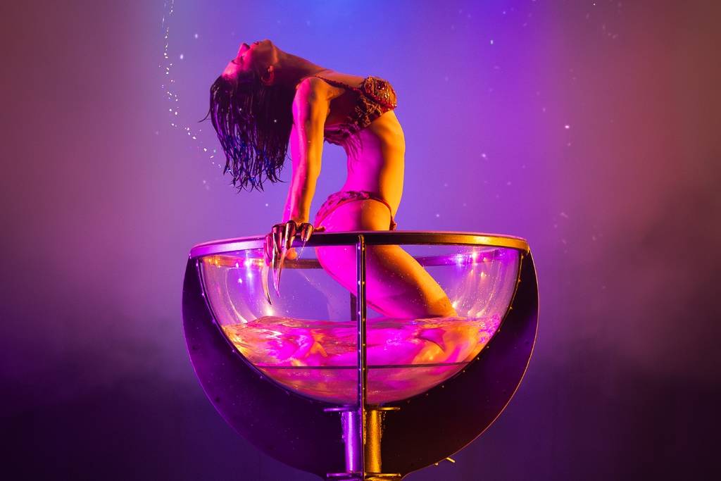 Burlesque performers wear horror-themed outfits onstage