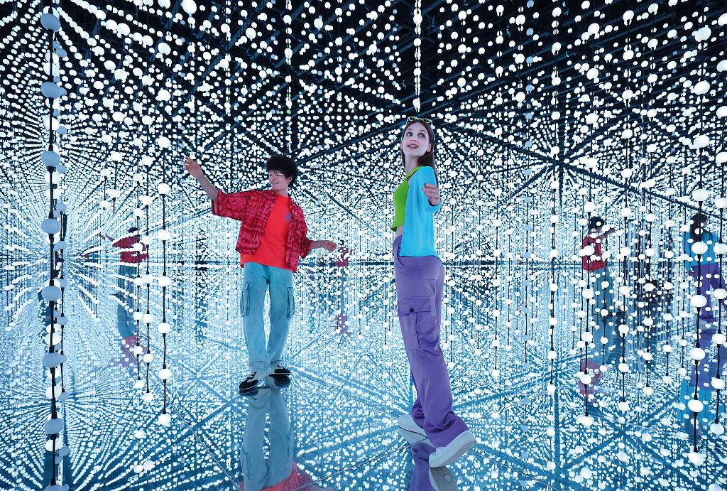 Two children in a room with LED lights at Bubble Planet