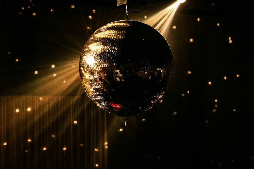 A disco ball reflects golden light