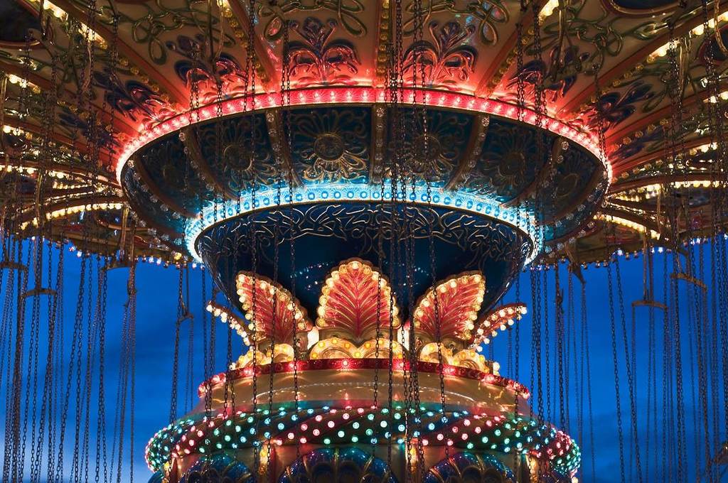 Close-up of an illuminated chain carousel at night