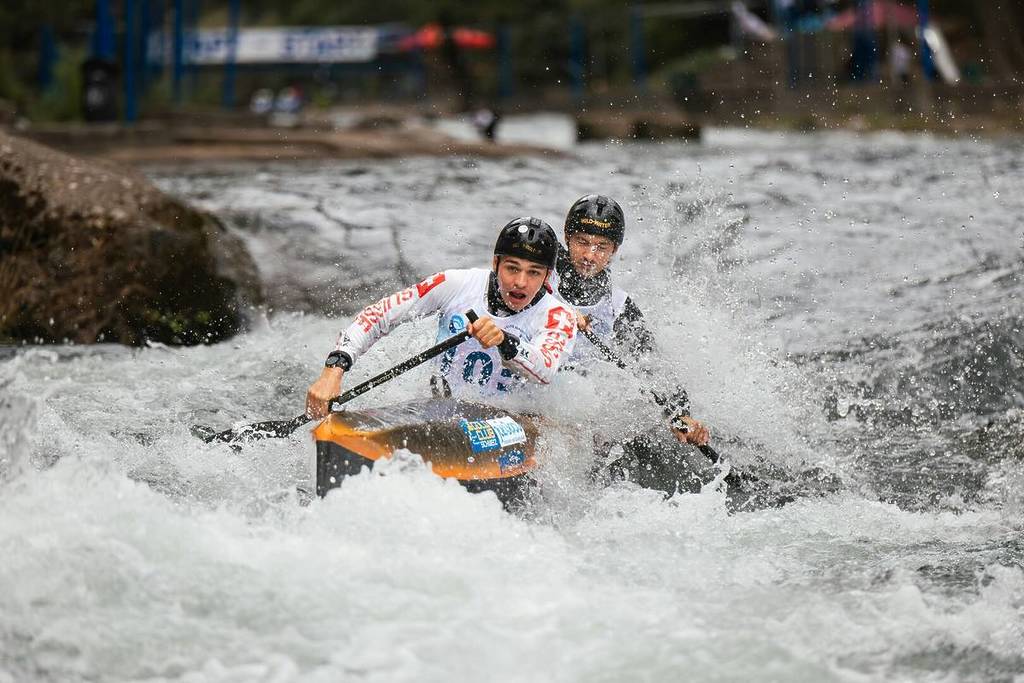 two canoeists on a whitewater course