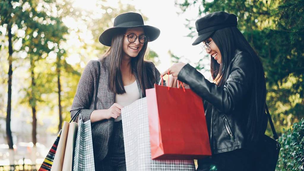 Two women show off their purchases