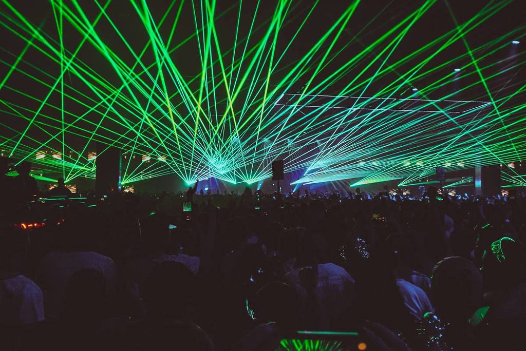 people raving under green lights, wonderful days