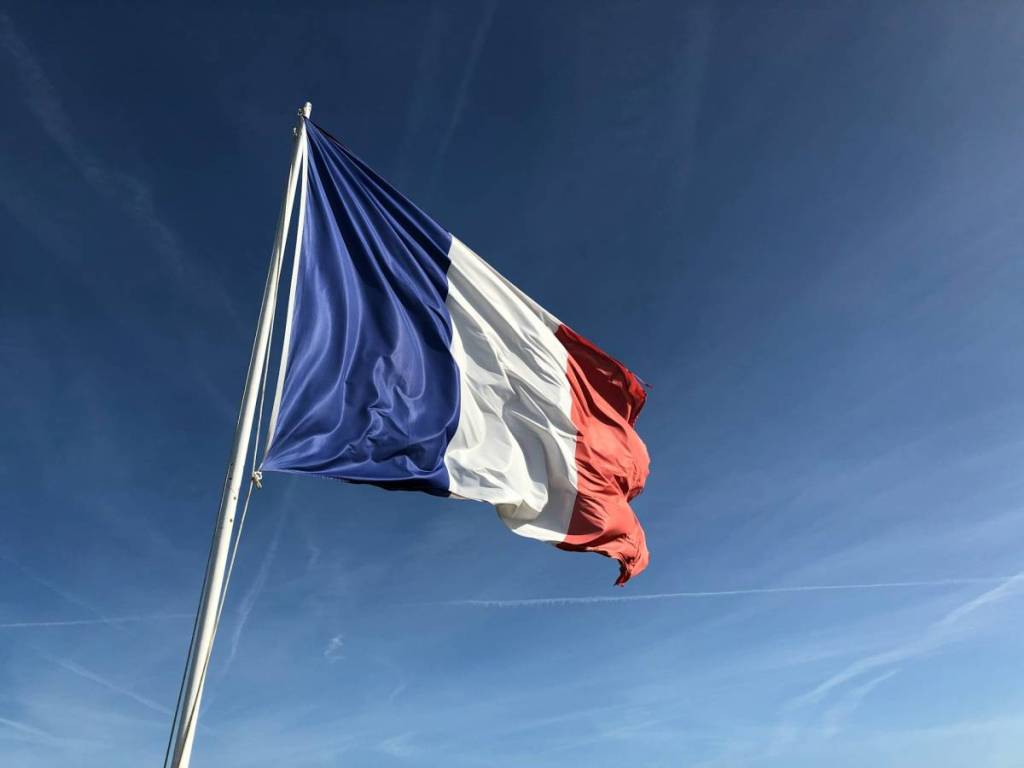 French flag against a blue sky