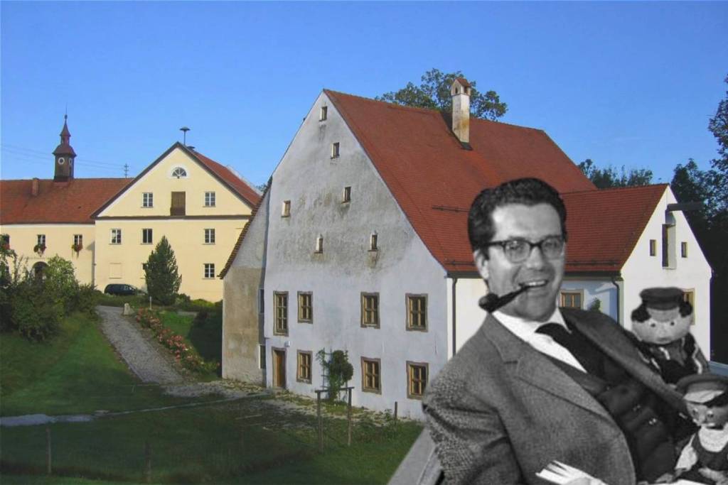 A photomontage of the smiling author Michael Ende with his pipe and Jim Knopf figurines in front of the Altes Schloss Valley.