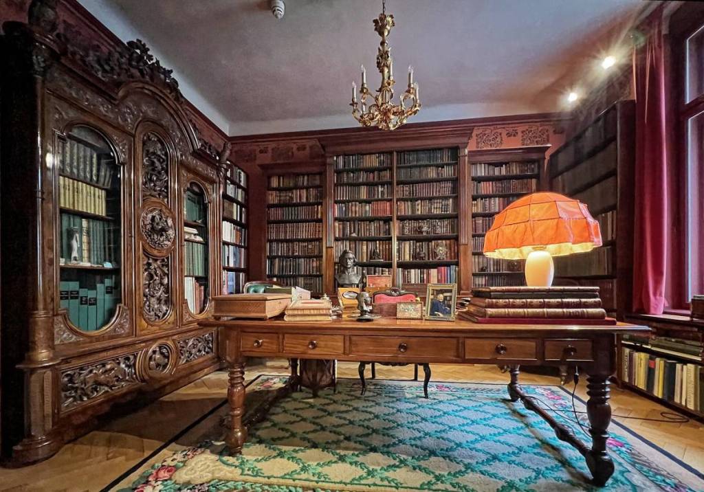 Von Parish Costume Library with a writing desk and chandelier