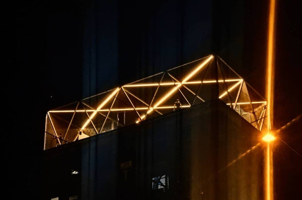 rooftop sports field at night with lighting