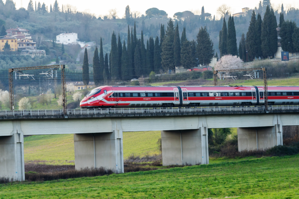 Frecciarossa train against a scenic backdrop