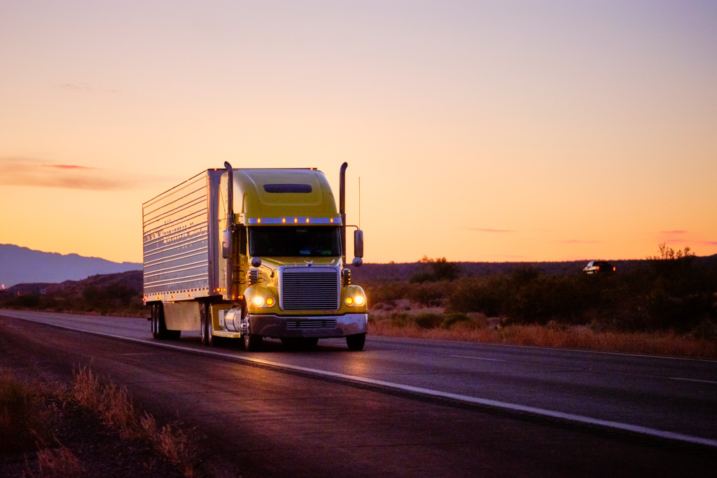 Freightliner truck on the road in the evening glow