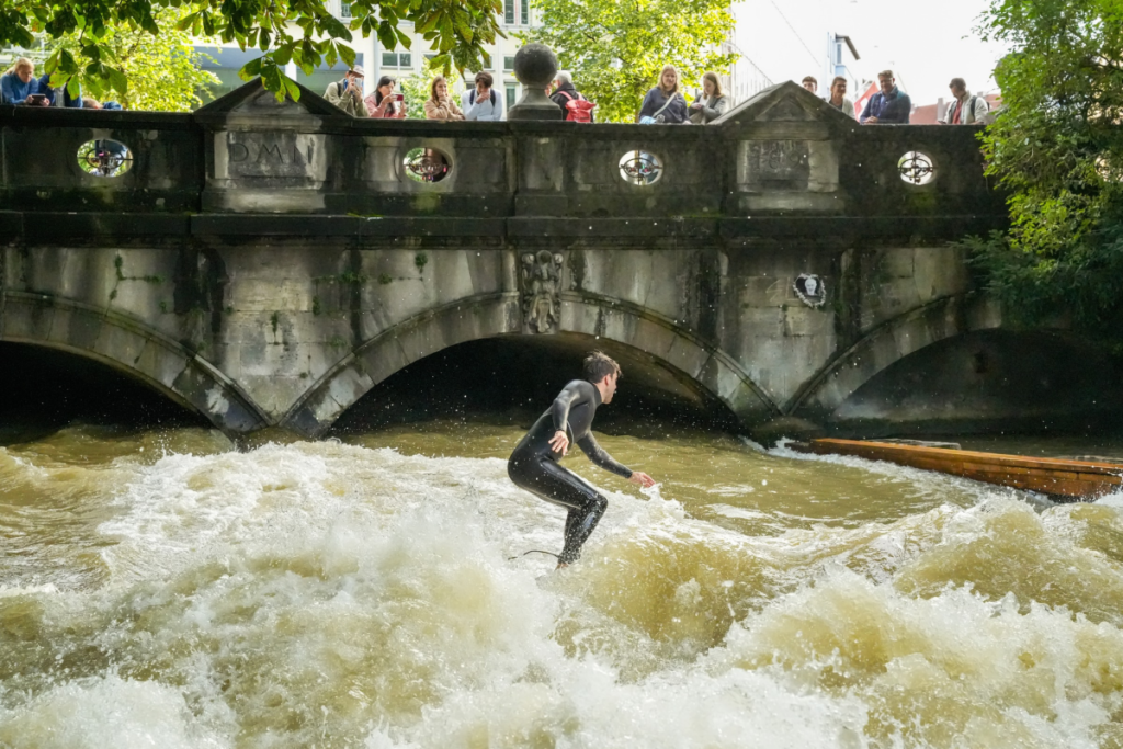 A person surfs the Eisbach wave in Munich