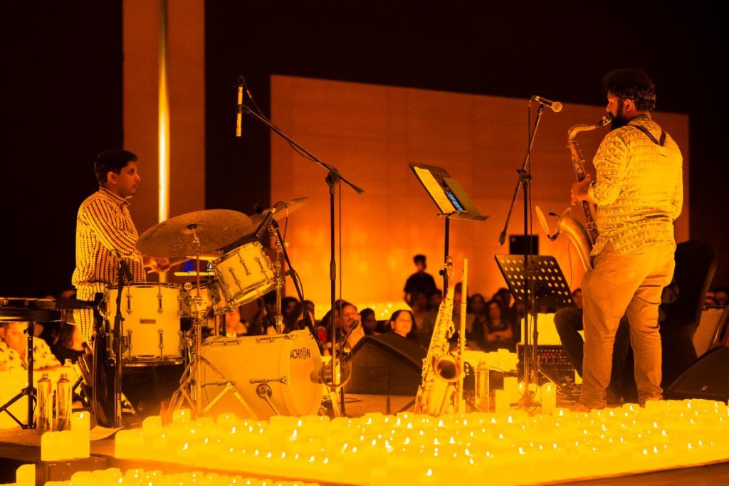 A band performing by candlelight at Grand Hyatt Mumbai.