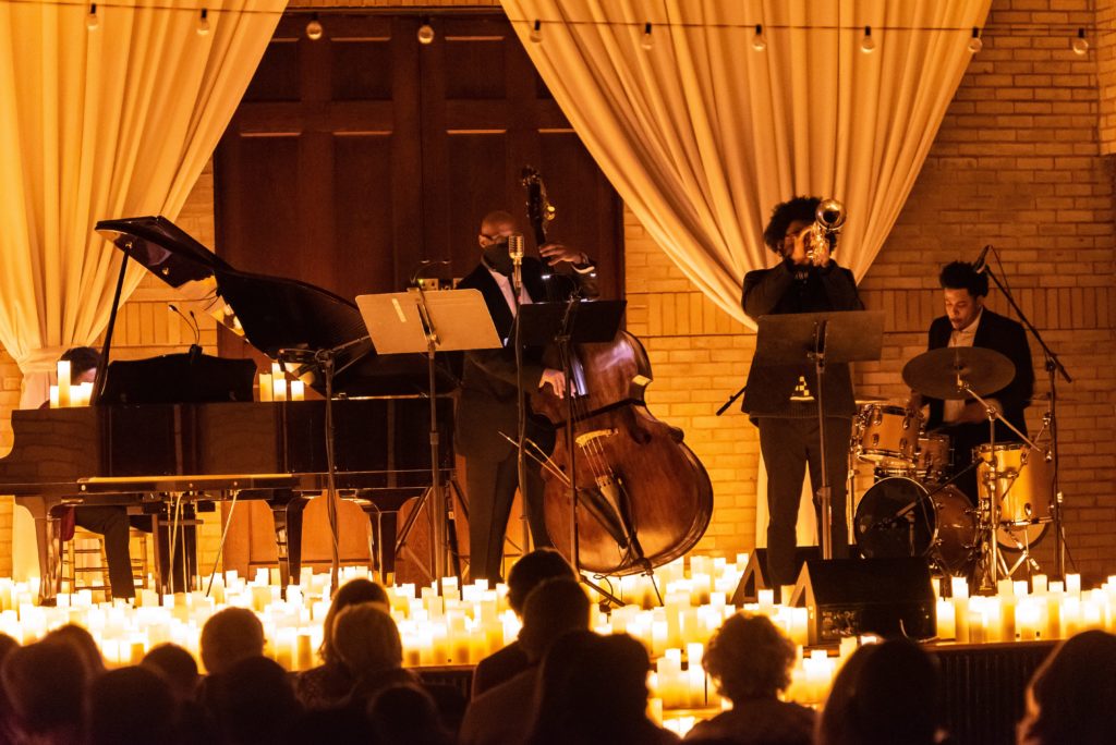 A band play before curtains at Candlelight concert.