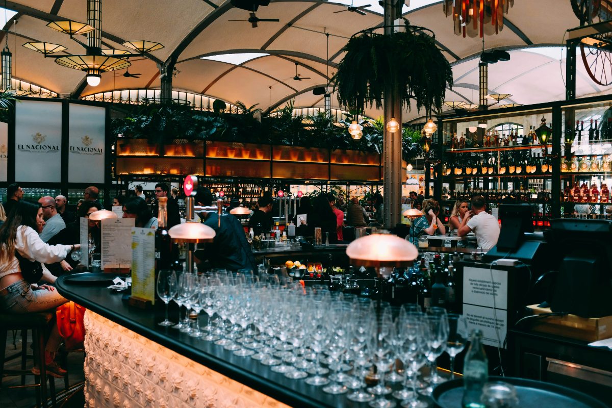 A rooftop bar with people drinking outside