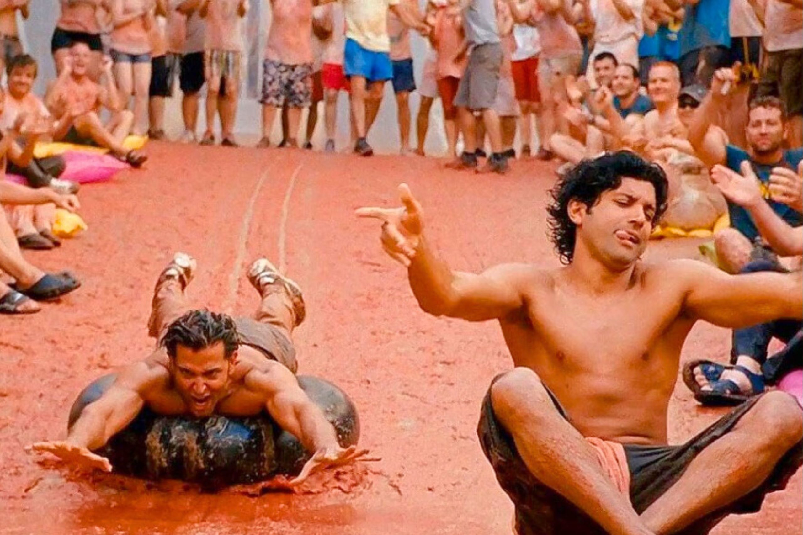 a still photo of actors Hrithik Roshan and Farhan Akhtar in the movie Zindagi Na Milegi Dobra enjoying the tomatina festival in spain
