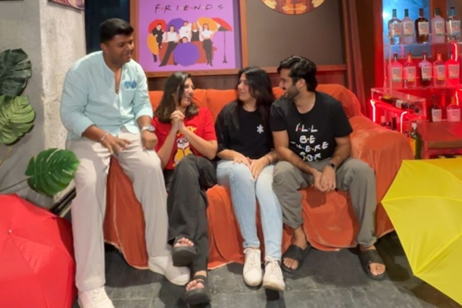 Friends sitting on the central perk orange couch replica in Sthamba Mumbai