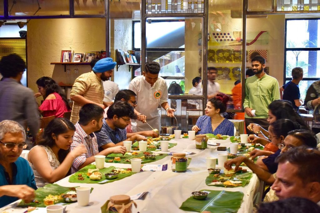 People serving and enjoying a community meal Independence Day Daawat at The Bombay Canteen