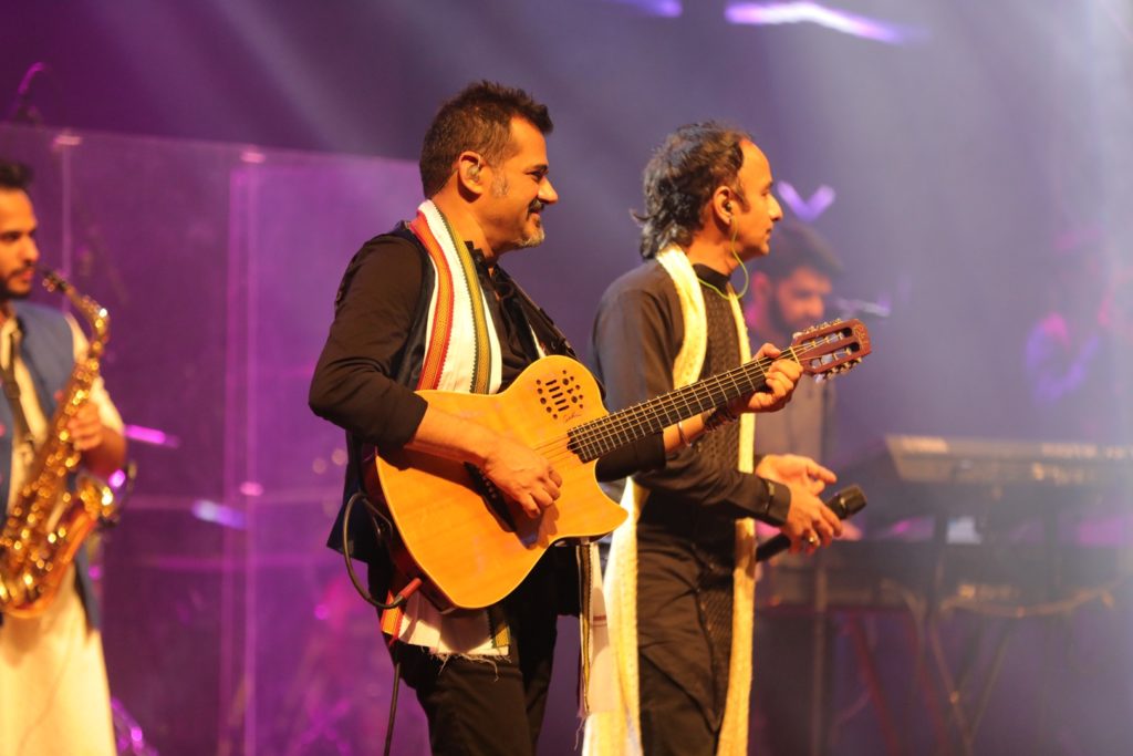 Two members of Shankar–Ehsaan–Loy performing on stage.