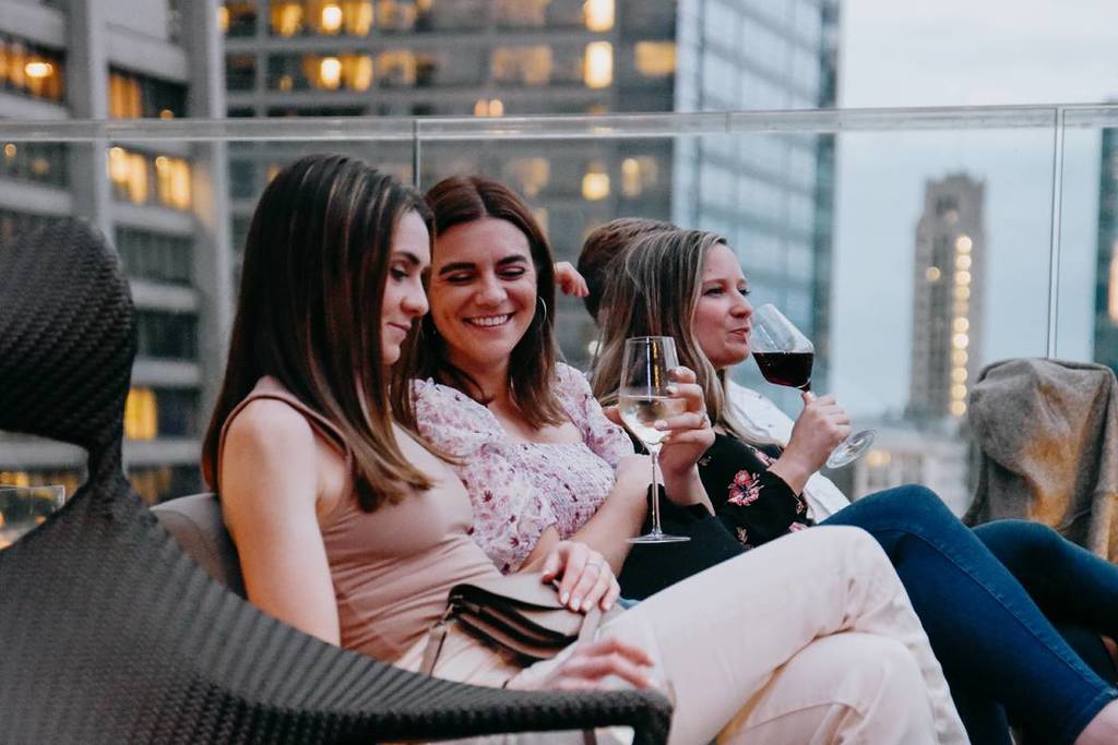 guests sipping wine on rooftop