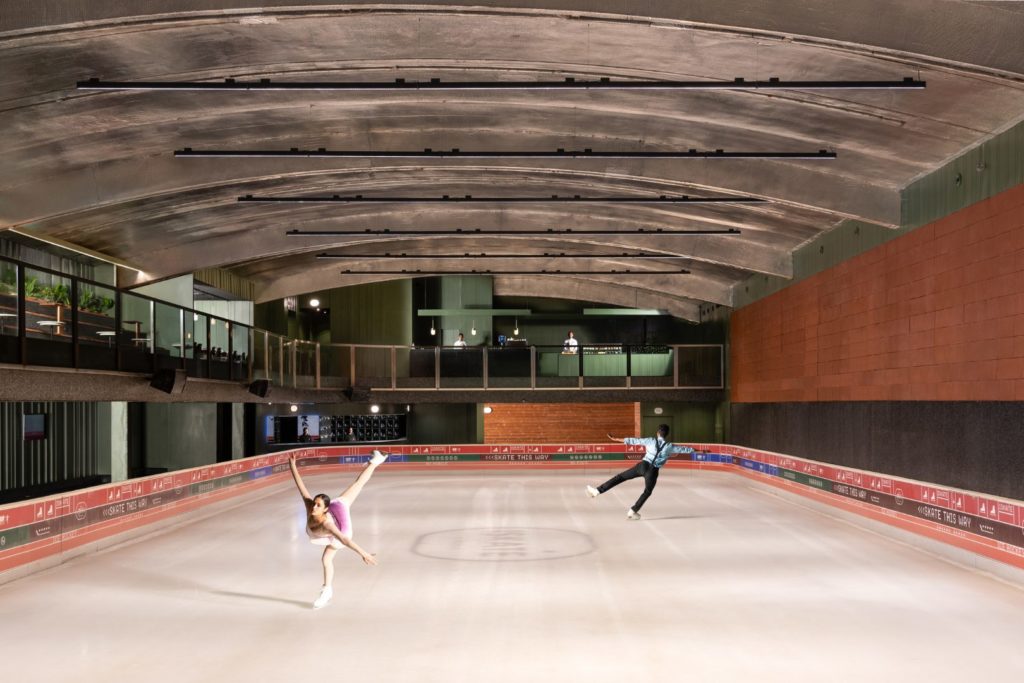 A man and woman showing off their figure skating skills at ISKATE by Roseate's 15,000 square ft ice rink