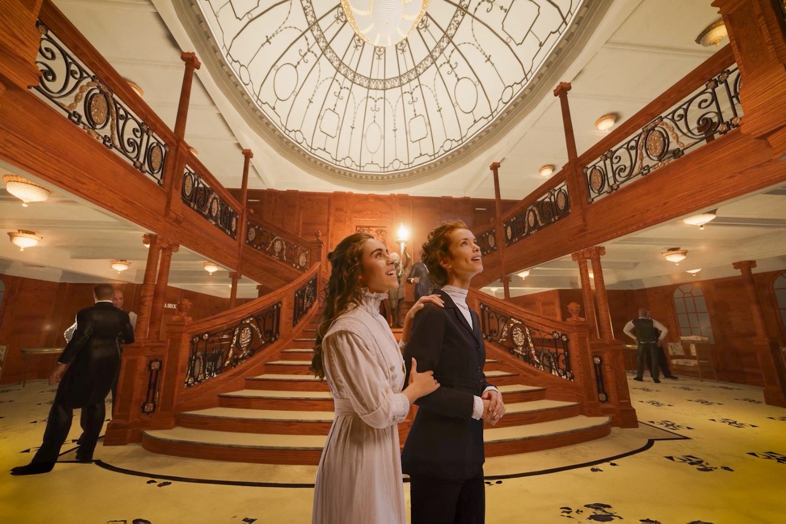 A couple exploring the Grand Staircase at Titanic: A Voyage Through Time