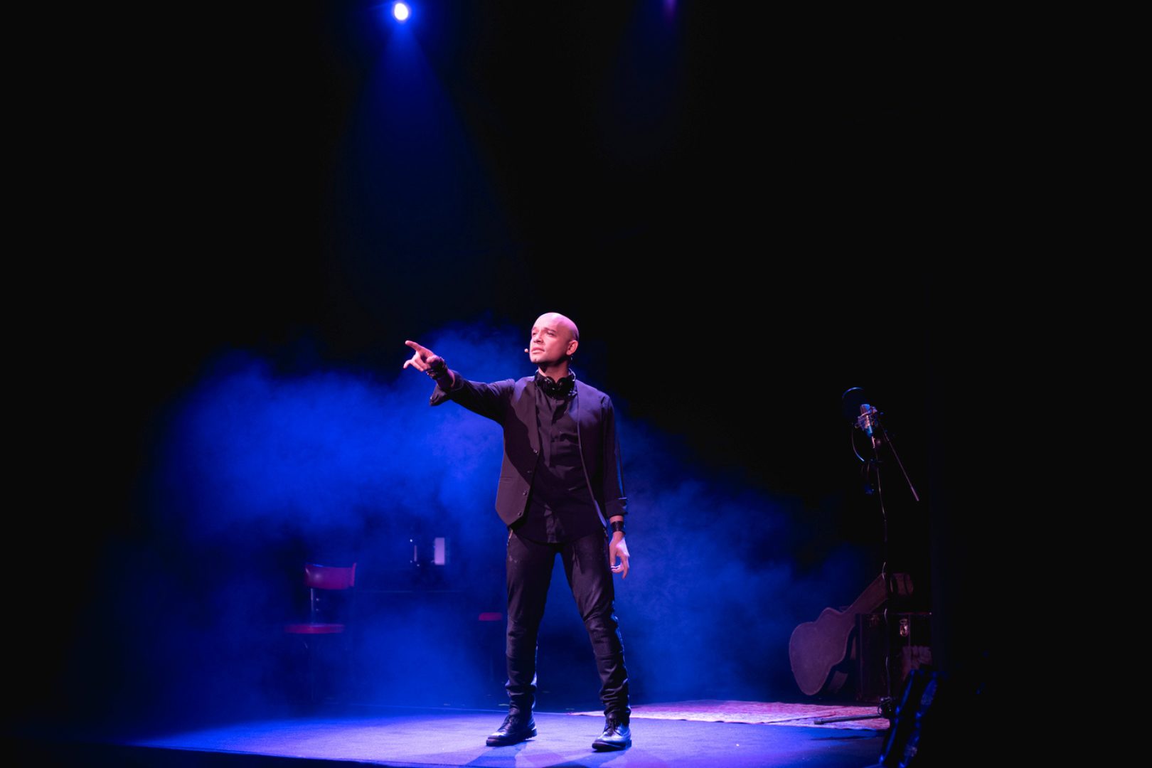 Julian Fontalvo pointing out towards the audience on stage at The Imitator