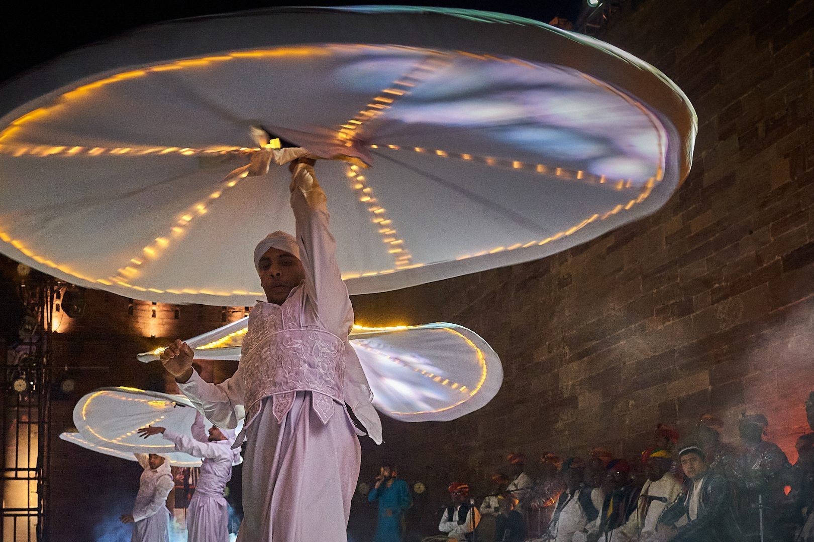 Whirling dancers performing for a crowd