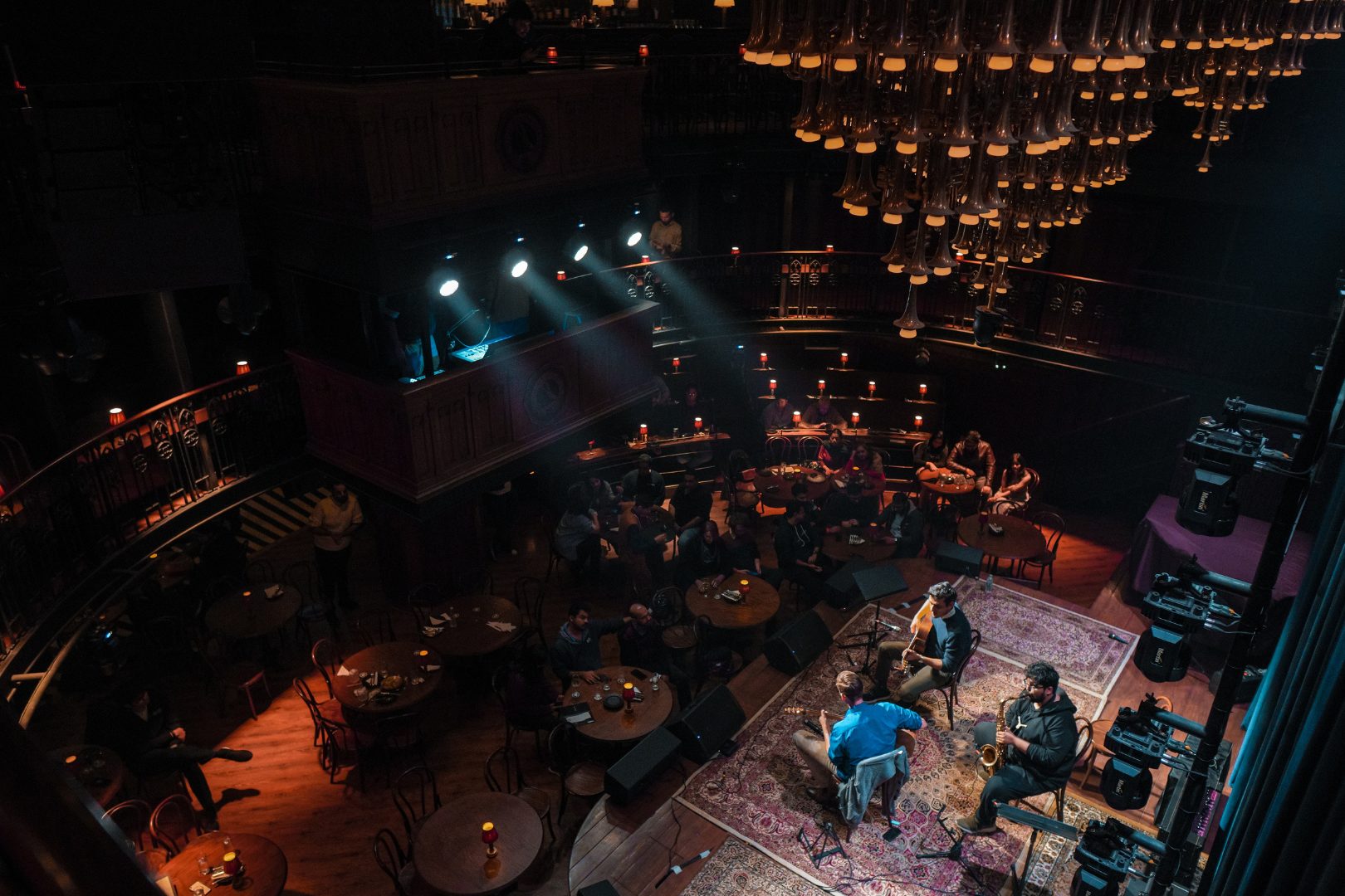An overhead view of an audience watching one of The Piano Man's performances on stage