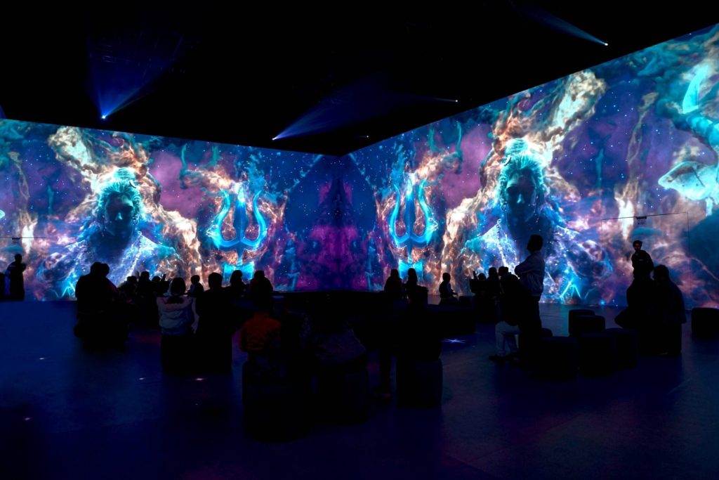 The silhouette of visitors surrounded by Shiva's image at Shiva Immersive 