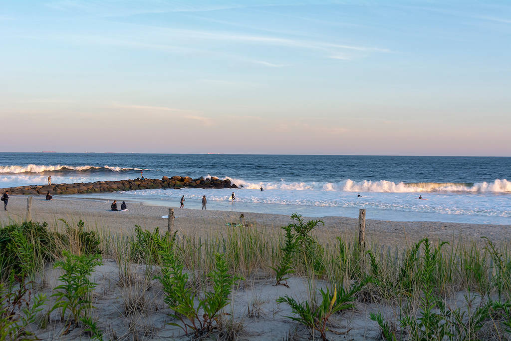Looking Over a Sand Dune from the Boardwalk at Rockaway Beach near Beach 67th Street at Sunset