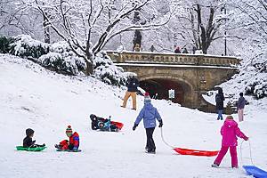 NEW YORK, NEW YORK - DECEMBER 14: Children go sledding in Central Park on December 14, 2025 in New York City. Snow fell across the region Saturday night into Sunday morning, with as much as five inches accumulating in some locations. (Photo by Ryan Murphy/Getty Images)