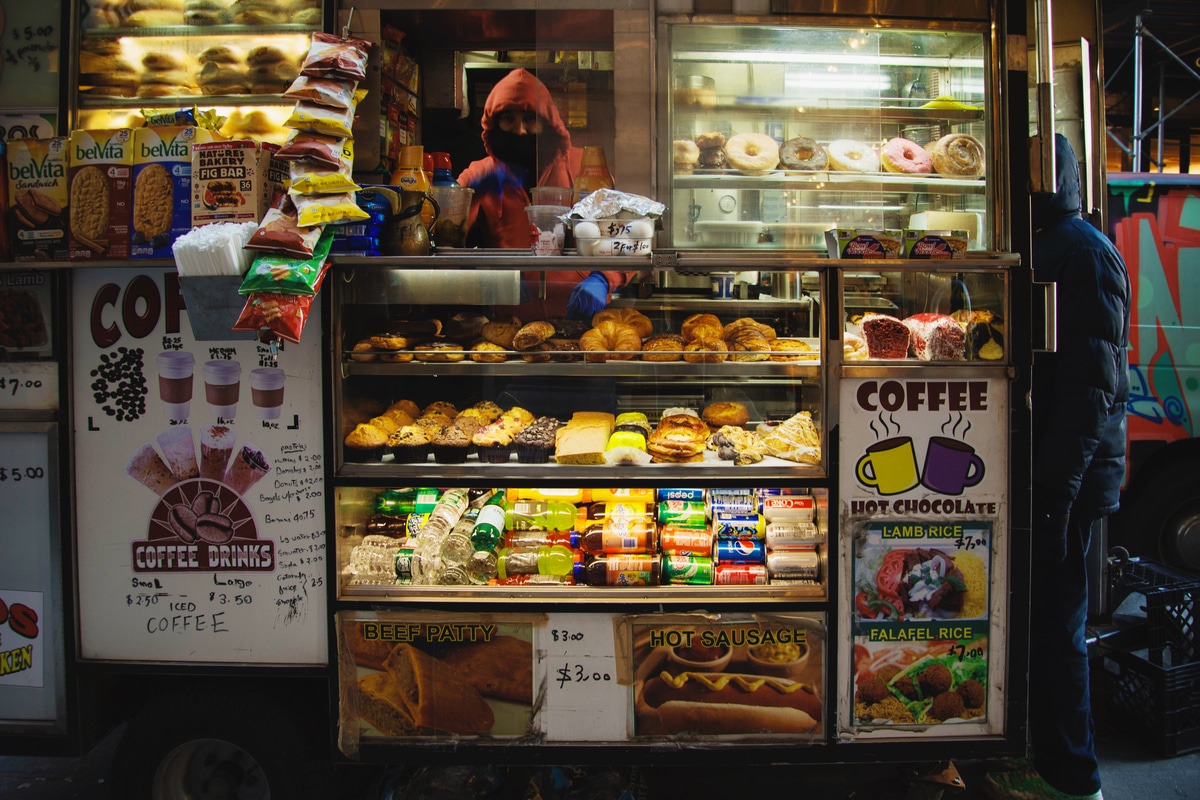 Street vendor selling breakfast and snacks in the Little Italy Neighborhood, bundled up for warmth on a cold morning.