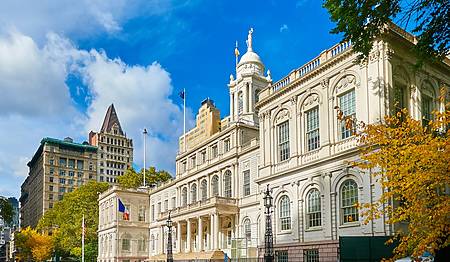 New York city government City Hall building in City Hall Park in the Civic Center area of Lower Manhattann. View from Nassau street and Brooklyn Bridge side.