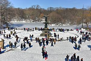 New Yorkers walking on snow at Bethesda Fountain in Central Park