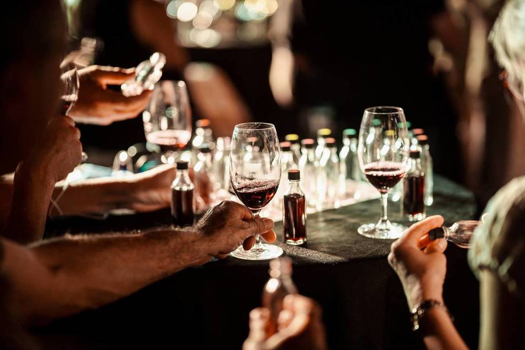 A close up of a table packed with wine glasses during a wine tasting