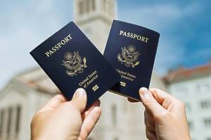 Two people holding up a U.S. passport